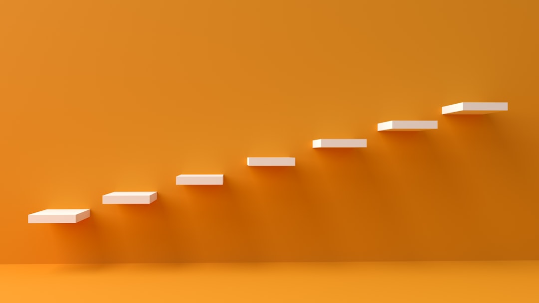 white steps rising on orange wall