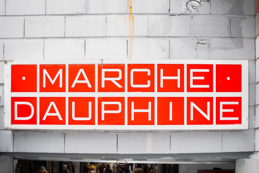 Marche dauphine sign on white brick wall