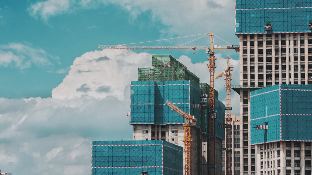 Construire une maison durable au Maroc a group of tall buildings under a cloudy blue sky