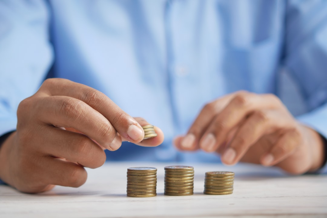 Investissement immobilier au Maroc pour les Français a person stacking coins on top of a table